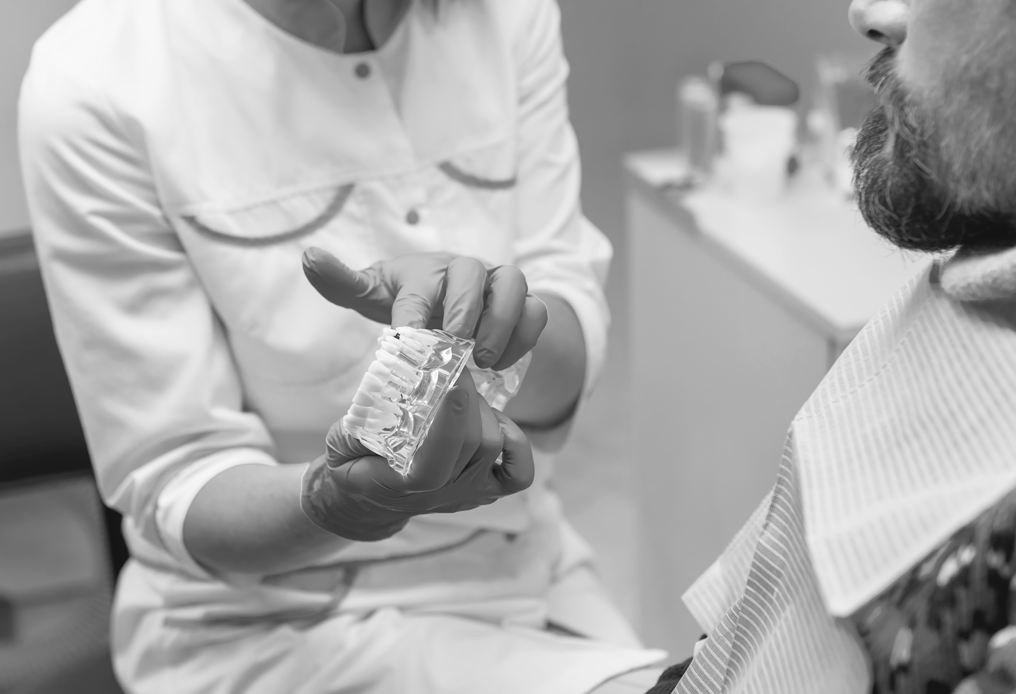 Shot of a young dentist getting ready to conduct a procedure on his patient.